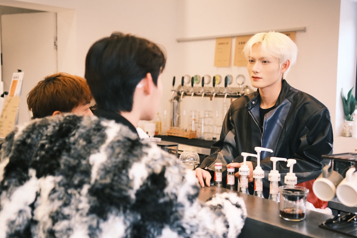 a man sitting at a counter in front of a woman