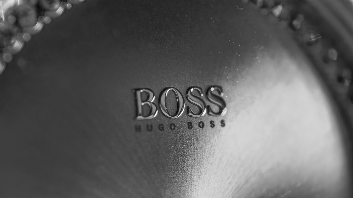 Close-up of a hugo boss logo on a textured surface.
