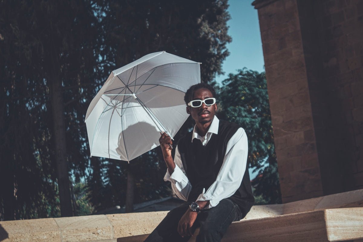 Woman holding a white umbrella outdoors