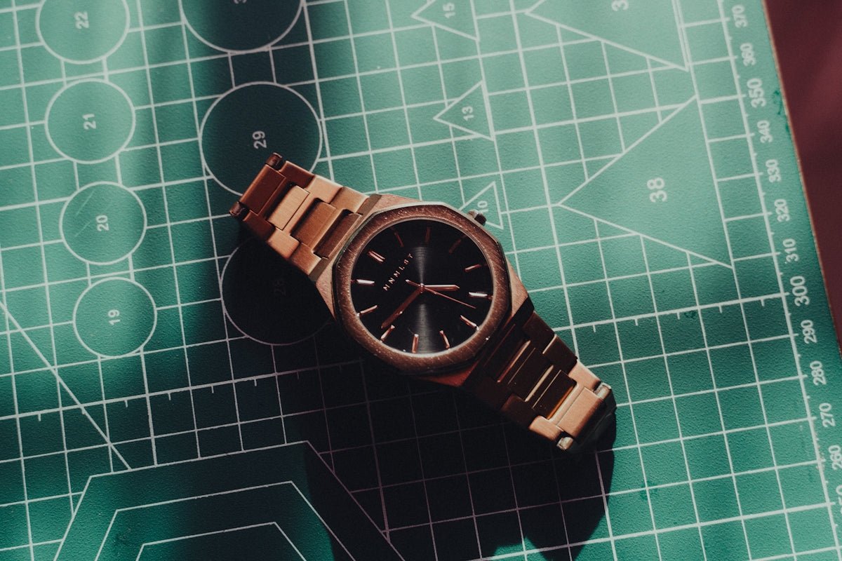 Wooden watch resting on a green cutting mat.