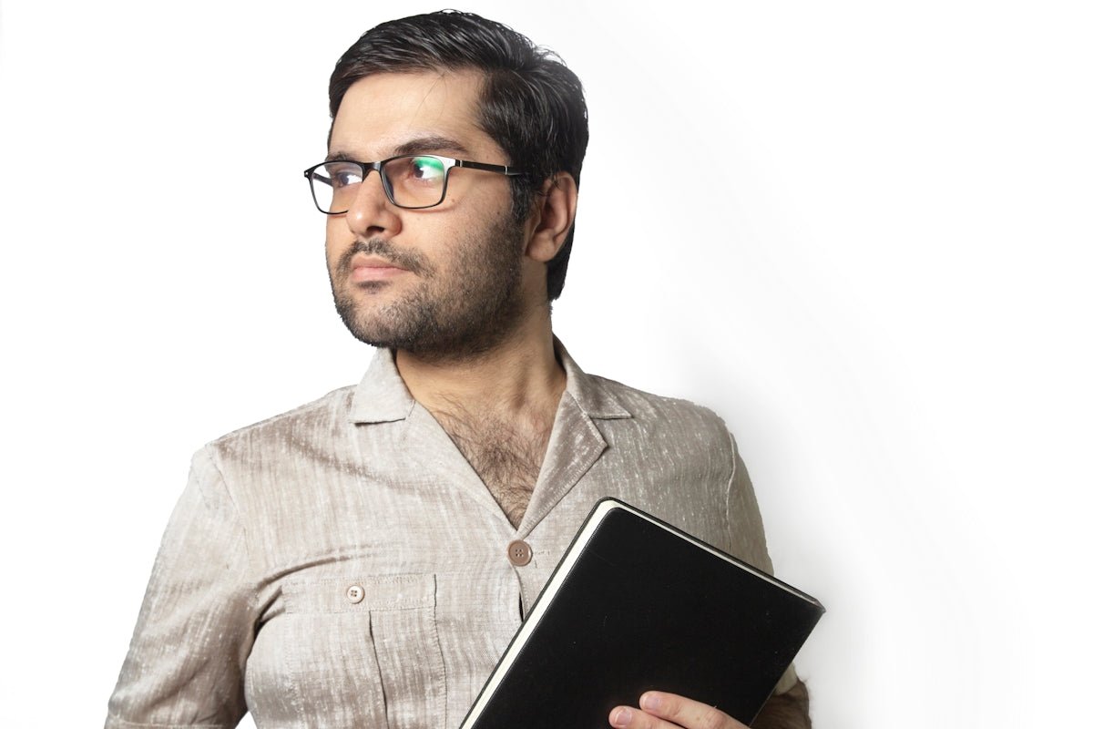 man in gray dress shirt holding black tablet computer