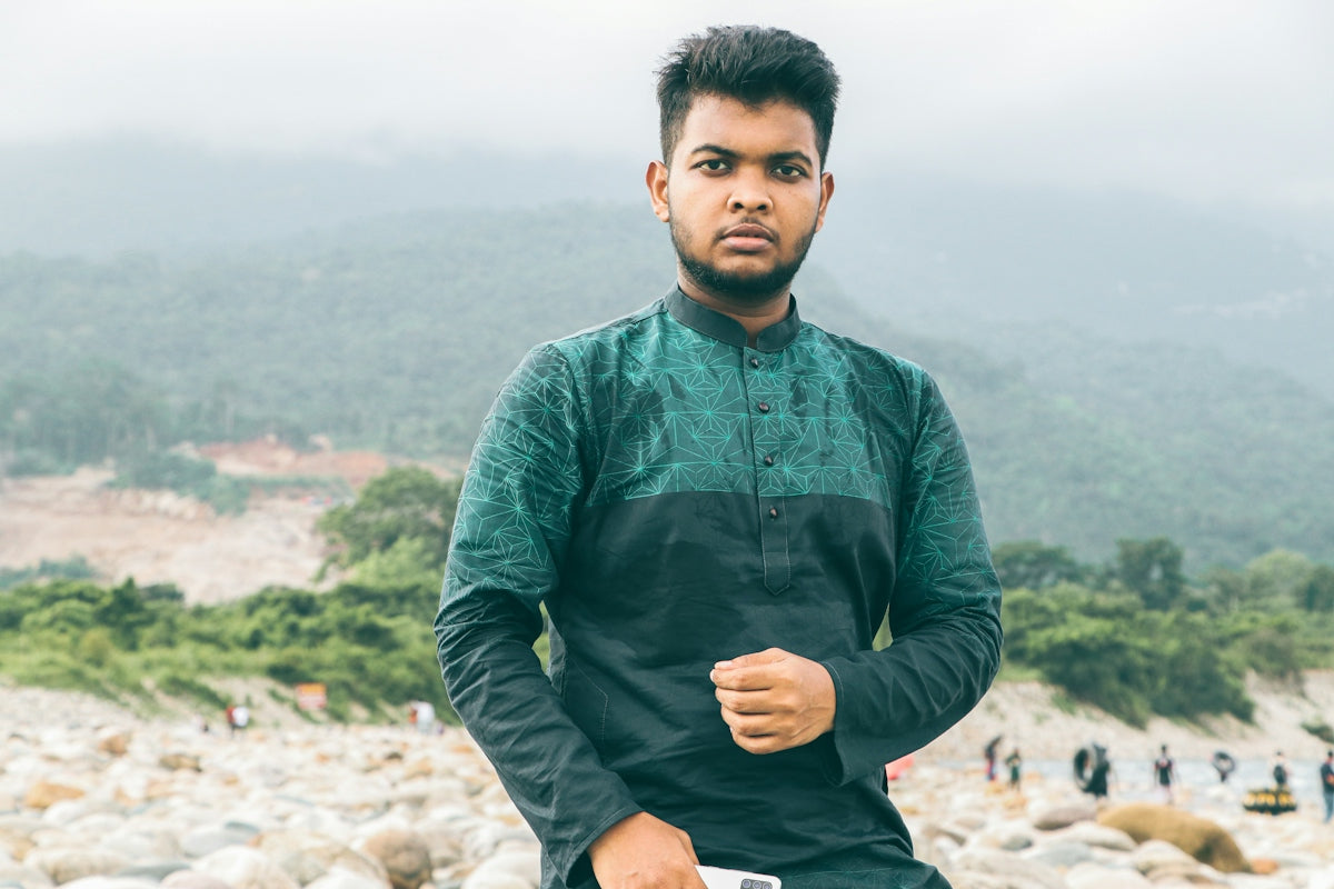 a man standing in front of a mountain