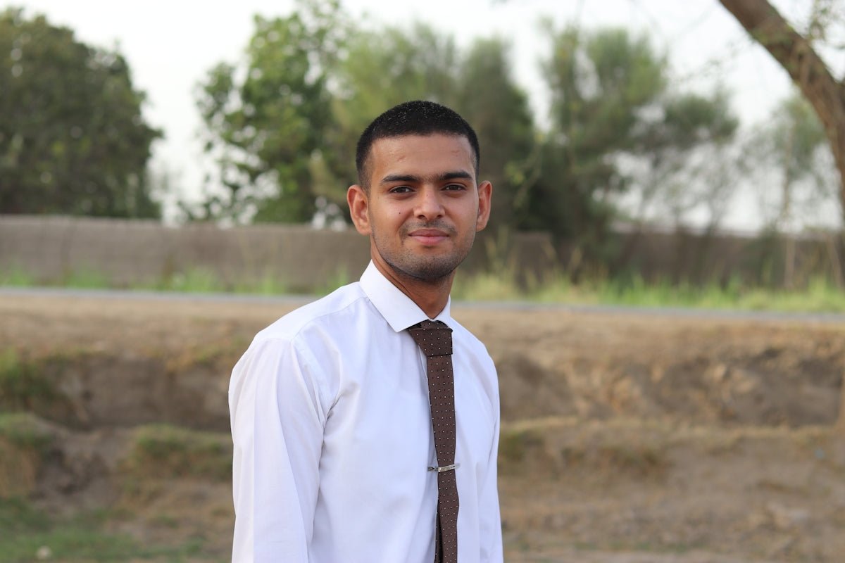 a man in a white shirt and brown tie