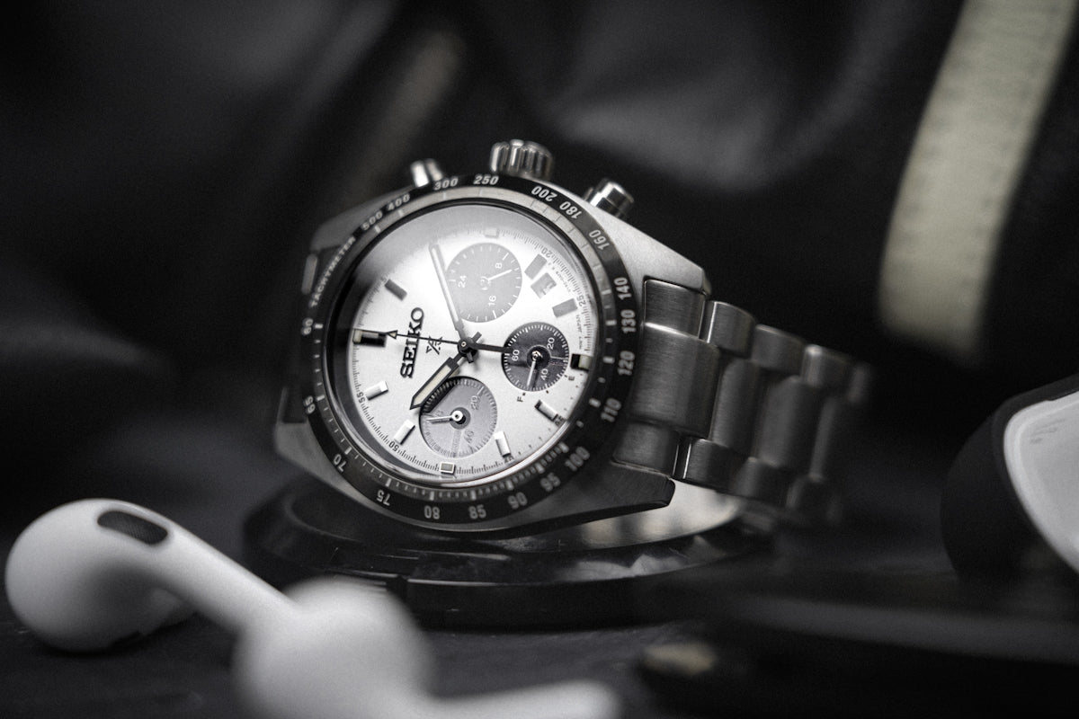 a hand holding a watch